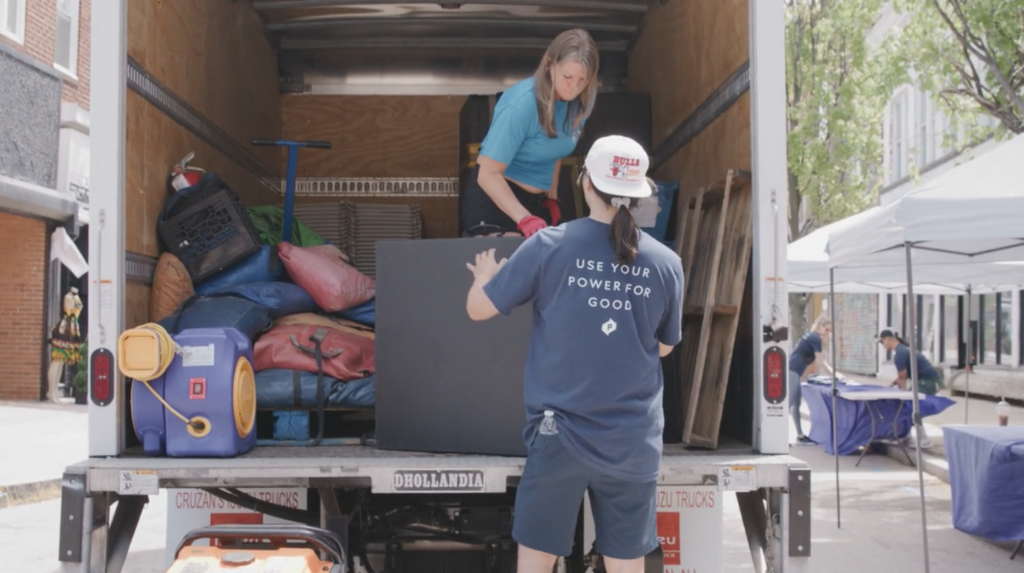 volunteer helping unload truck